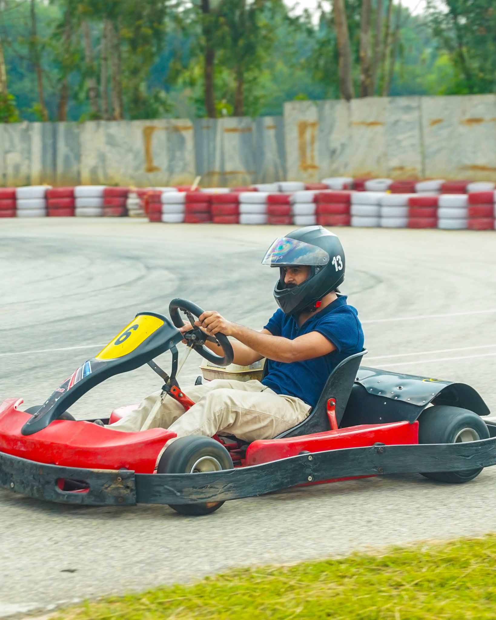 A go-kart driver turns on a racing track.